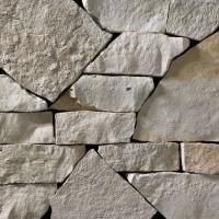 A light grey webwall stone veneer with subtle golden accents that is perfect for application to any hardscape idea on the exterior or interior of any home or landscape.