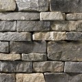 A dark grey stone veneer with light tan accents perfect for any hardscape idea on the exterior or interior of any home or landscape.