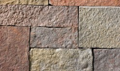 A grey, lilac, pink, and red stone veneer with some purple hues and tan or golden accents perfect for any hardscape idea on the exterior or interior of any home or landscape.