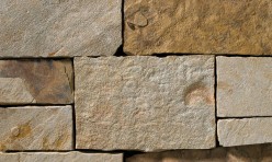 A brown, tan, and grey stone veneer perfect for any hardscape idea on the exterior or interior of any home or landscape.