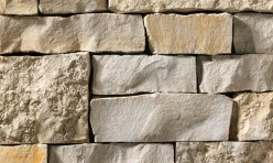 A light grey and tan stone veneer with a mixture of smooth and rough textures perfect for any hardscape idea on the exterior or interior of any home or landscape.