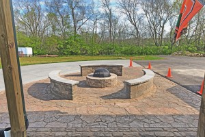 A completed paver patio, valencia fire pit, and sitting walls in Waynesville, OH using products from Belgard and Techo-Bloc.