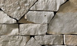 A light grey webwall stone veneer with subtle golden accents that is perfect for application to any hardscape idea on the exterior or interior of any home or landscape.