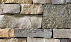 A mixture of tan, golden, grey, and light grey stone veneer with a blend of textures rough to smooth. Perfect for any hardscape idea on the exterior or interior of any home or landscape.