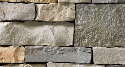 A mixture of tan, golden, grey, and light grey stone veneer with a blend of textures rough to smooth. Perfect for any hardscape idea on the exterior or interior of any home or landscape.