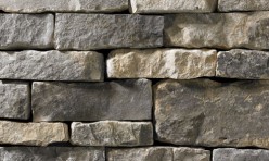 A dark grey stone veneer with light tan accents perfect for any hardscape idea on the exterior or interior of any home or landscape.