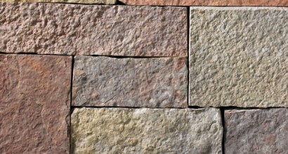 A grey, lilac, pink, and red stone veneer with some purple hues and tan or golden accents perfect for any hardscape idea on the exterior or interior of any home or landscape.