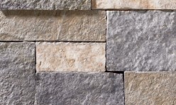 A grey and tan stone veneer with both warm and cool tones and a few rose-colored accents perfect for any hardscape idea on the exterior or interior of any home or landscape.