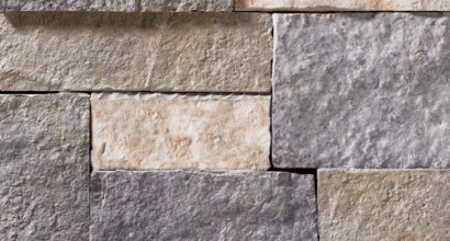 A grey and tan stone veneer with both warm and cool tones and a few rose-colored accents perfect for any hardscape idea on the exterior or interior of any home or landscape.