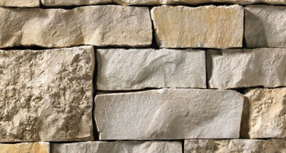 A light grey and tan stone veneer with a mixture of smooth and rough textures perfect for any hardscape idea on the exterior or interior of any home or landscape.