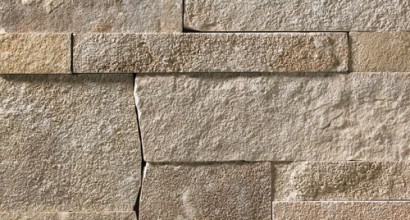 A grey and tan stone veneer with a slightly warm hue and a few rose-colored accents perfect for any hardscape idea on the exterior or interior of any home or landscape.