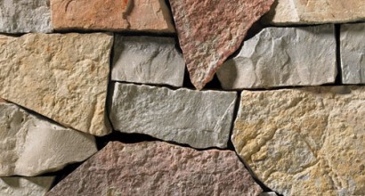 This stack ledgestone features light grey and tan tones complimented with a warm, red accent.