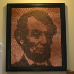 Pennies in a pattern forming a portrait of Abraham LIncoln.