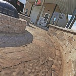 A completed paver patio, valencia fire pit, and sitting walls in Waynesville, OH using products from Belgard and Techo-Bloc.