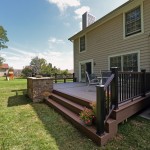 A completed TimberTech deck with a stone planter made from Techo-Bloc Semma wall block.